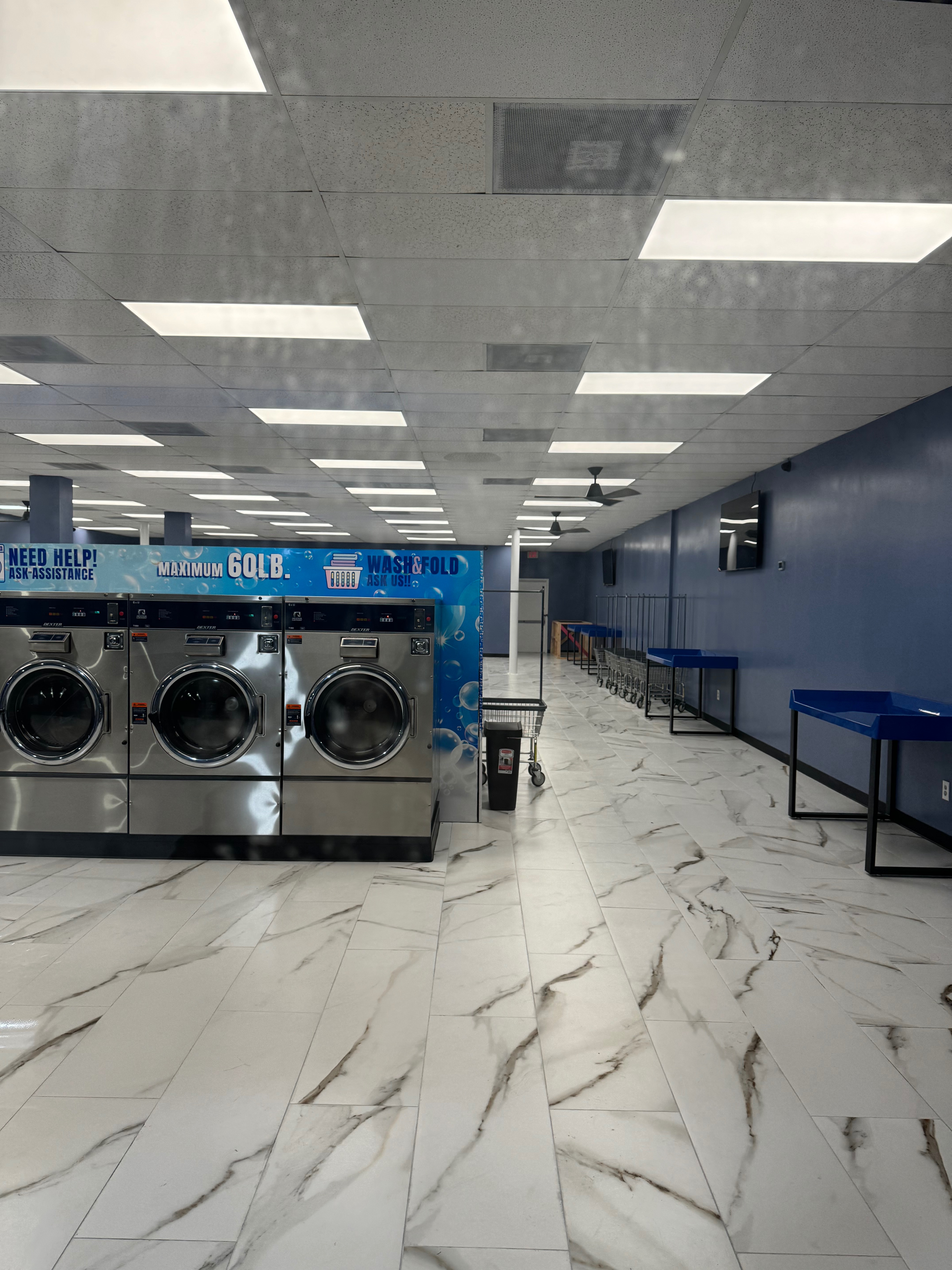 Open folding area with tables and laundry carts
