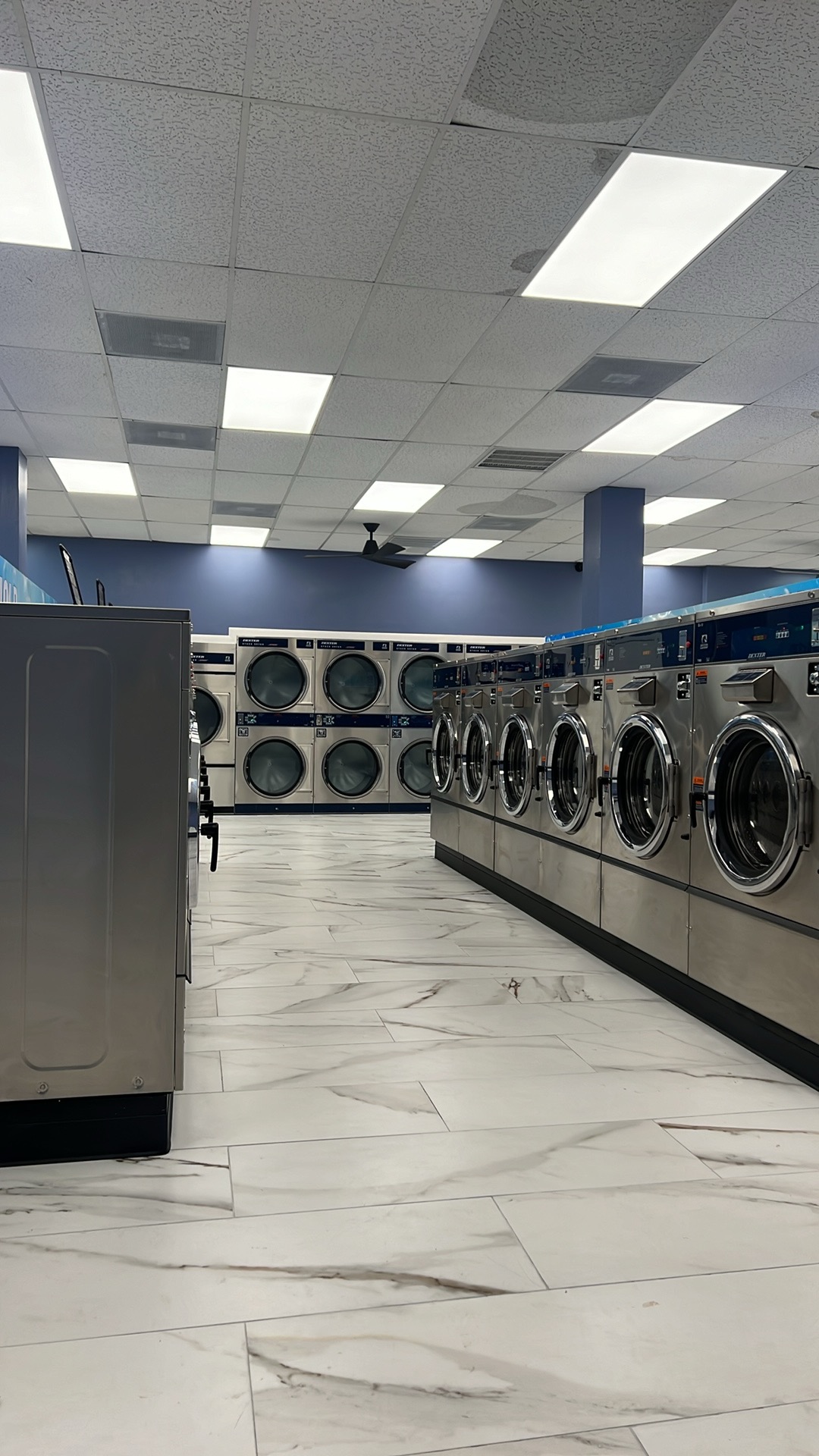 Clean interior with washers and stacked dryers