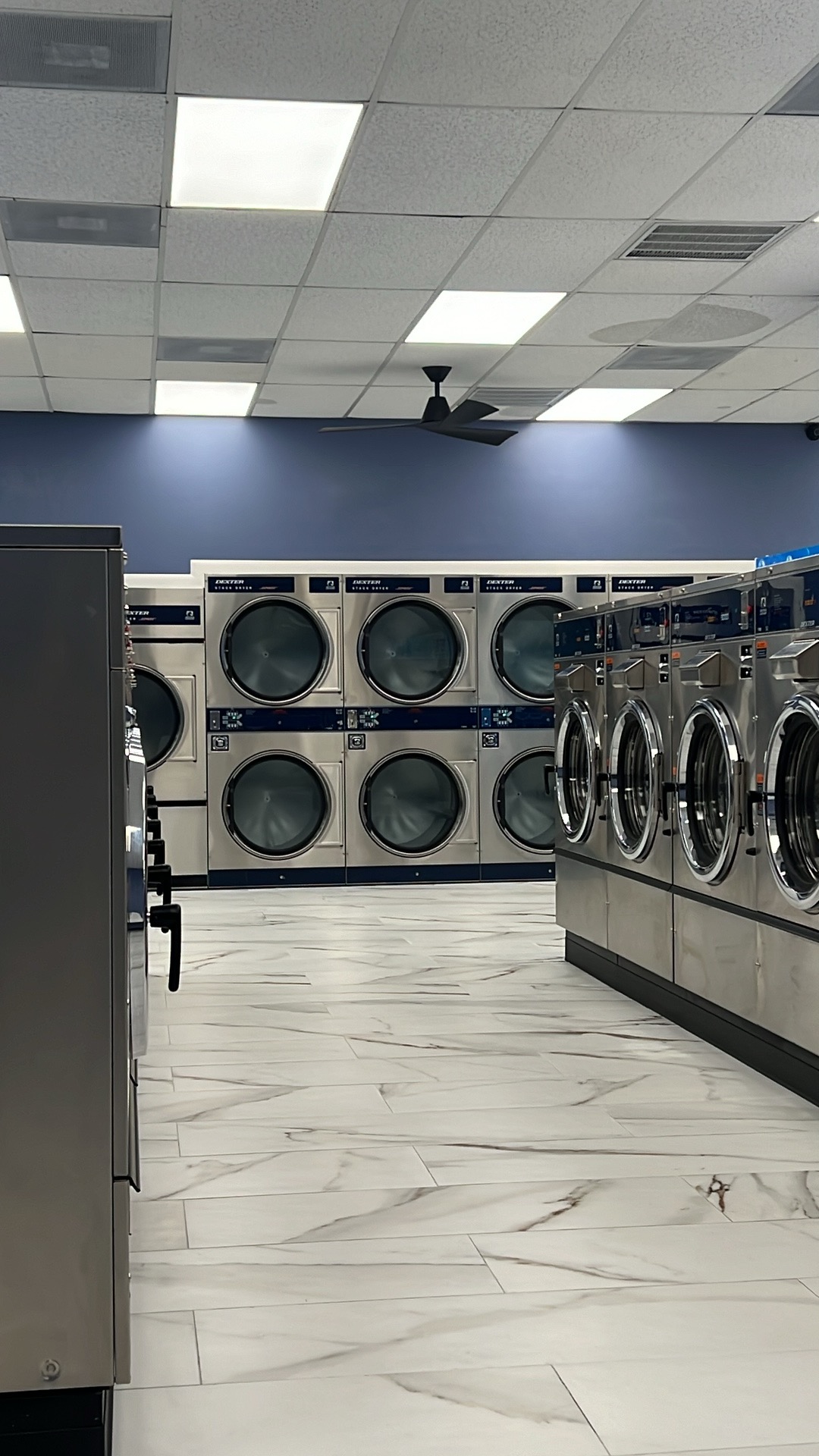 Stacked Dexter dryers next to a row of washers